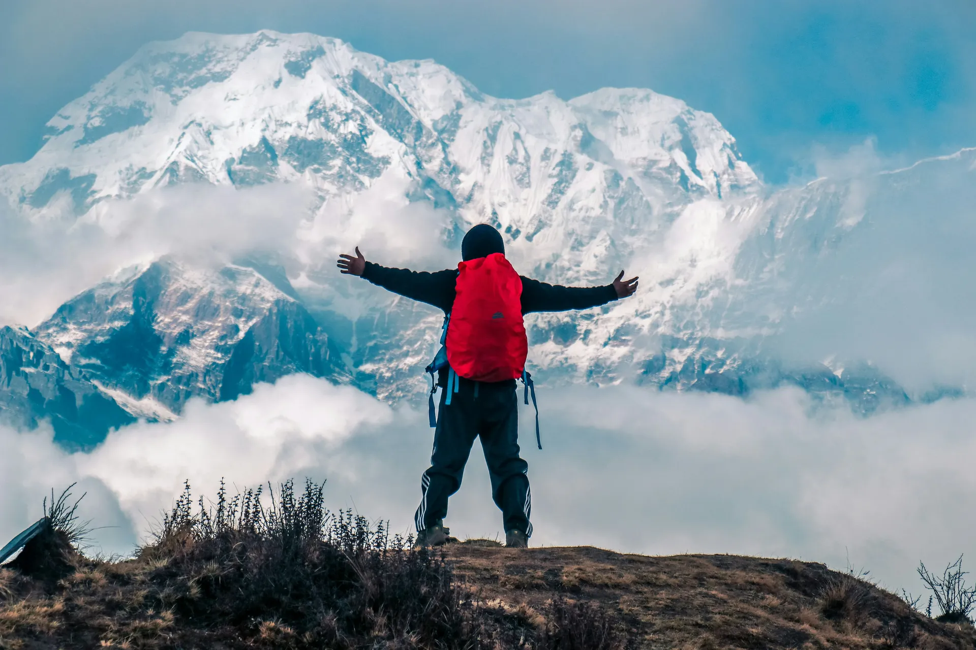Trekker arms outstretched before Annapurna